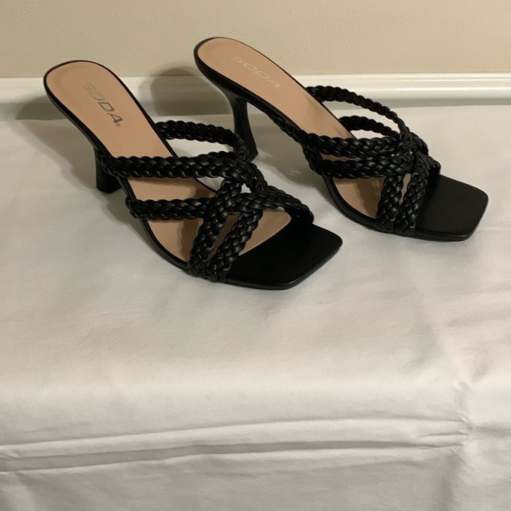 New In Box Soda brand black crisscross braided strap sandals with 3.5” heels.